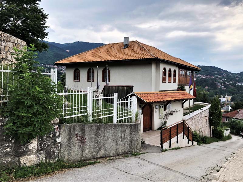 building on hill alongside street