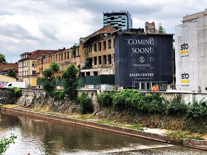 abandoned building with sign reading "Coming Soon!"