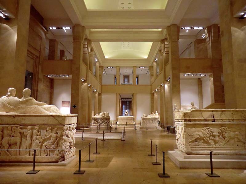 The interior of the National Museum of Beirut is a two-story gallery with white stone statuary