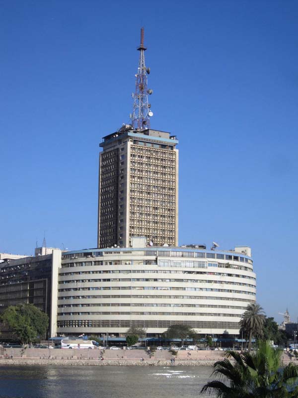 curved building with tower in background