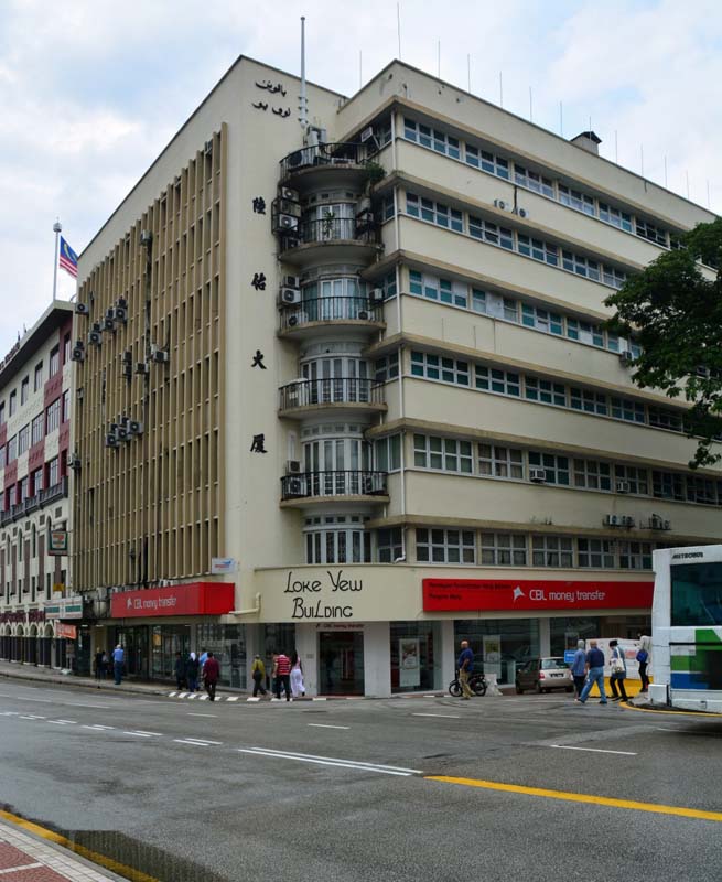 multistory building with curved balconies at corner of street