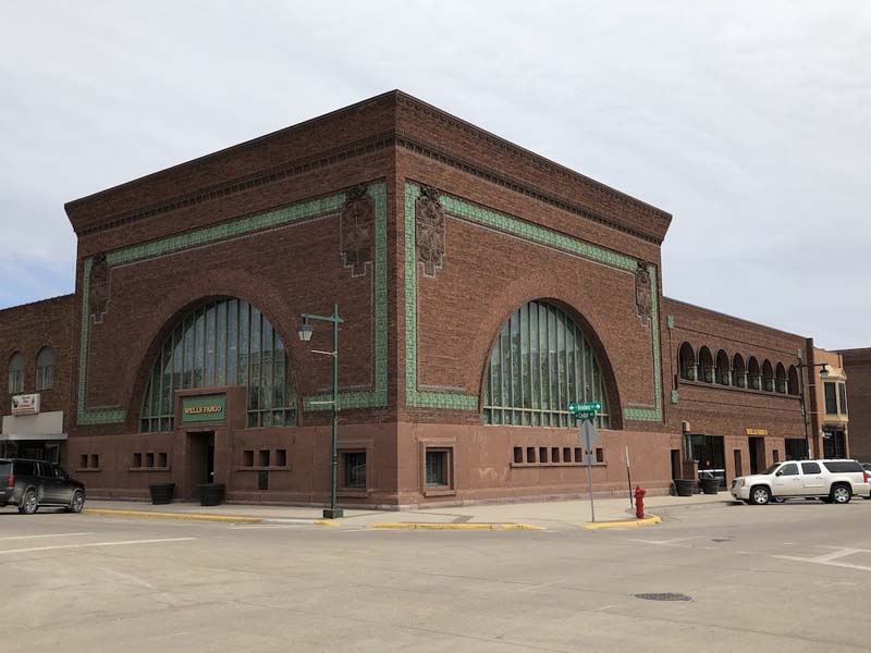 corner of brick building with large arched windows