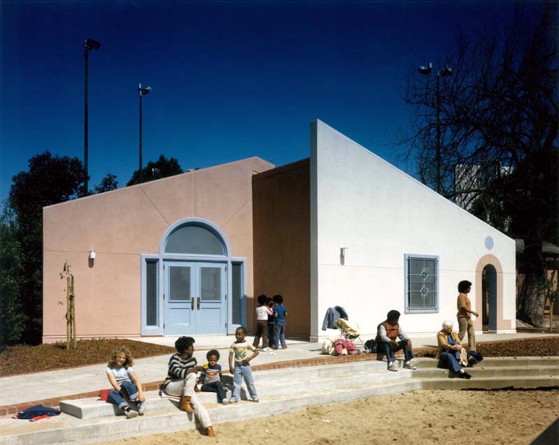 adults and children on steps in front of postmodern building