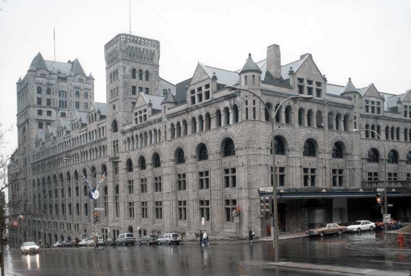 large stone building with arches and collonade