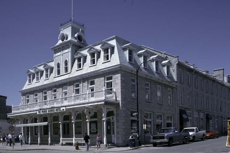 A long white building with mansard roof